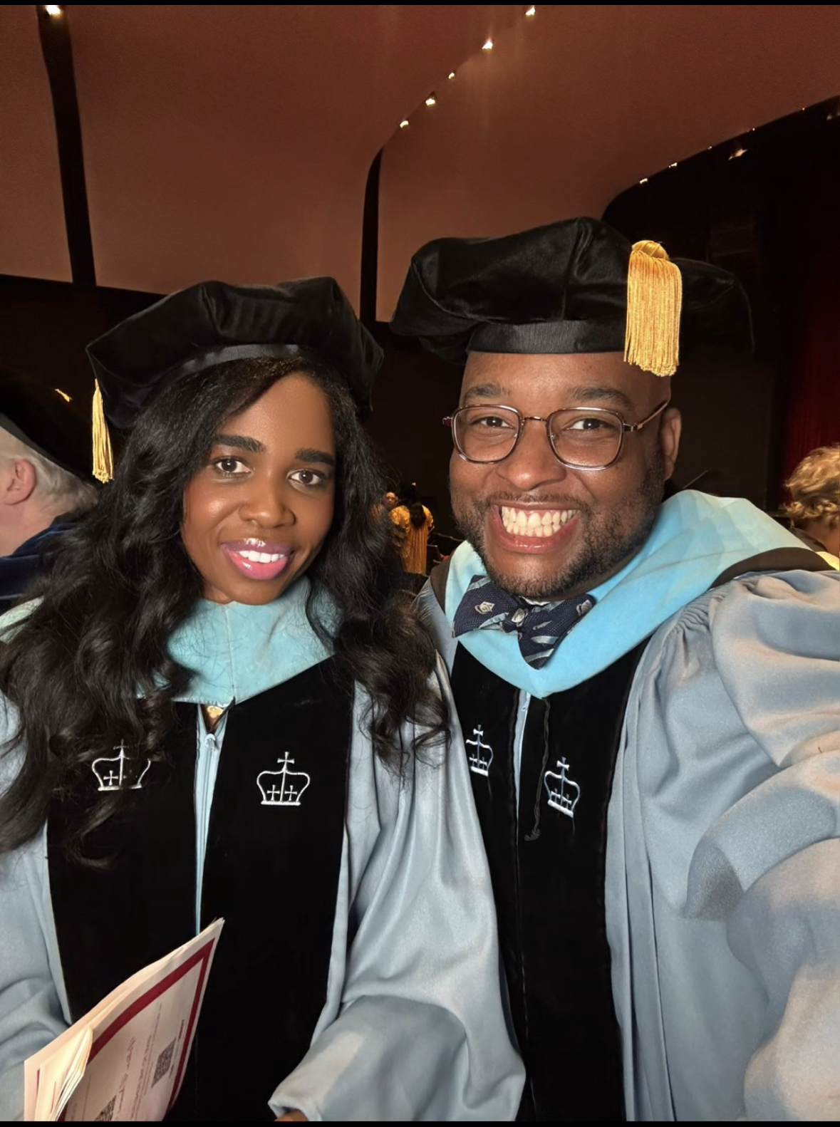 Dr. Erin Jacques and Dr. Vincent Jones II together in academic regalia at graduation
